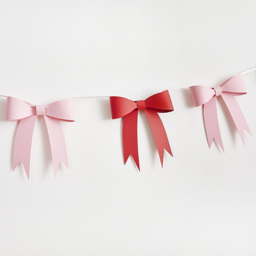 Bunting with pink and red bows on a white background
